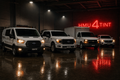 HMU4TINT Fleet Partner Plan — fleet of white commercial work vehicles with dark tint parked in shop under red HMU4TINT neon