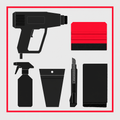 Window tint installation tool kit rental - flat lay of heat gun, squeegees, knife, spray bottle, and microfiber